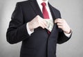 Corruption. Man putting money in suit jacket pocket. Royalty Free Stock Photo