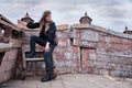 Corsair woman with a knife on board a wooden ship against a gloomy sky on Halloween Royalty Free Stock Photo