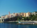 Corsica Bastia port view from sea on harbour with green lighthous church and old town blue sky