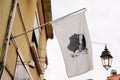 Corsican flag hanging in the street has a balcony in an old town of the island of beauty