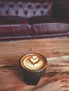 Cortado coffee with latte art on a wooden table