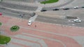 Cortege of wedding cars top view, white and black cars drive through the city in row