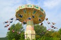 The Wave Swinger Chair o plain carousel people on swinging seats on chains. Royalty Free Stock Photo