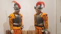 Mannequins dressed in costumes of battle soldiers of the Middle Ages with metal protections and metal helmet