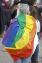 Coruna-Spain. Older person with the LGBT flag on his back during the gay pride demonstration
