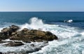 Seascape with waves breaking against the rocks and blue sky. Galicia, Spain. Royalty Free Stock Photo