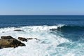 Seascape with waves breaking against the rocks and blue sky. Galicia, Spain. Royalty Free Stock Photo