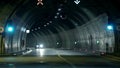 Corvette driving through the tunnel towards the camera