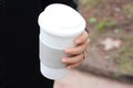Cose up of woman hands holding paper coffee cup