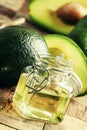 Cosmetic avocado oil in a glass jar, selective focus