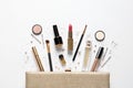 Cosmetic bag and different luxury makeup products on white background