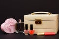 Cosmetic bag, perfume, nail polish and gift box on black background Royalty Free Stock Photo