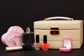 Cosmetic bag, perfume, nail polish and gift box on black background Royalty Free Stock Photo