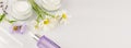 Cosmetic banner with organic creams and wild flowers