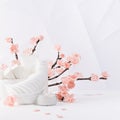 Cosmetic, beauty products for makeup, cleansing skin in white bottles, spring pink sakura flowers, toiletry in soft light white.