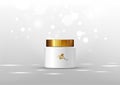 Cosmetic bottle for cream. White jar and gold glossy lid on the gray background for ads.