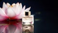 Cosmetic bottle with eau de toilette or perfume on water surface with beautiful lotus with copy space Royalty Free Stock Photo