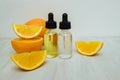 Cosmetic bottle with pipette, oil and orange Royalty Free Stock Photo