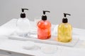 Cosmetic bottles with shower gel, body lotion or shampoo and bath towels. Bathroom accessories Royalty Free Stock Photo