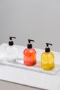 Cosmetic bottles with shower gel, body lotion or shampoo and bath towels. Bathroom accessories