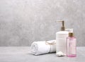 Cosmetic bottles and white towel on table empty space background.Shower items set.Spa objects.Face and body care products