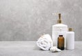Cosmetic bottles and white towel on table empty space background.Shower items set.Spa objects.Face and body care products