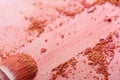 Makeup brush and crushed pink eye shadows Royalty Free Stock Photo