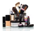 Cosmetic brush, eye shadow, liquid base, lipstick, jar cream isolated.