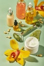 Cosmetic care products in glass bottles with orchid flowers - serums, cream, gel, oils. Concept for face and body care Royalty Free Stock Photo