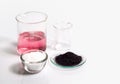 Cosmetic chemicals ingredient on white laboratory table. Potassium Permanganate Liquid, KMnO4 and Microcrystalline wax in glass