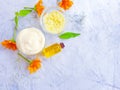 Cosmetic cream, calendula flower oil on a gray concrete backgroundcosmetic cream, calendula flower oil on a gray concrete backgrou Royalty Free Stock Photo