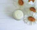 cosmetic cream camomile flower treatment wooden background Royalty Free Stock Photo