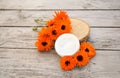 Cosmetic cream for cleansing the skin with calendula flowers. Medical Dermatology. Cream for body care with calendula. Fresh