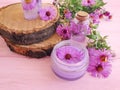 Cosmetic cream, extract, organic alternative chrysanthemum flower on a pink wooden background