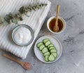 Cosmetic cream, face mask, scrub, cucumber, white bath towel Royalty Free Stock Photo