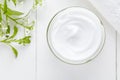 Cosmetic cream with herbal flowers on white background Royalty Free Stock Photo