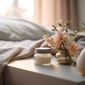 Cosmetic cream jar on bedside table with flowers in beige bedroom background, cream jar mockup Royalty Free Stock Photo