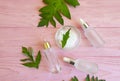 Cosmetic cream, leaf  wooden background Royalty Free Stock Photo