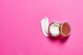 Cosmetic cream lotion opened container on bright pink background