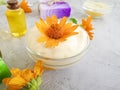 Cosmetic cream, oil, soap, calendula flower on a gray concrete background Royalty Free Stock Photo