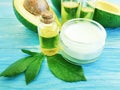 Cosmetic cream, oil, vitamin avocado health on a wooden background Royalty Free Stock Photo