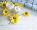 Cosmetic cream organic a jar yellow chrysanthemum flower white wooden, daisy, towel Royalty Free Stock Photo