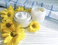 Cosmetic cream organic morning skincare a jar yellow chrysanthemum flower white wooden, daisy, towel Royalty Free Stock Photo