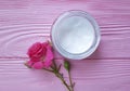 Cosmetic cream organic, roses, pink wooden table Royalty Free Stock Photo