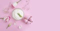 Cosmetic cream, health wellness rose flower on a colored background