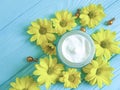 Cosmetic cream product wellness yellow chrysanthemum flowers protection spa camomile capsules on a blue wooden background Royalty Free Stock Photo