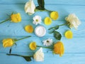 Cosmetic cream, yellow rose on blue wood beauty product wellness