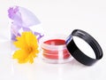 Cosmetic with a flower and violet crystal Royalty Free Stock Photo