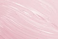 Cosmetic gel background. Face serum, clear beauty cream texture. Pink colored transparent skincare product close-up