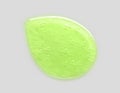 Cosmetic green liquid drop aloe vera with bubbles on grey background